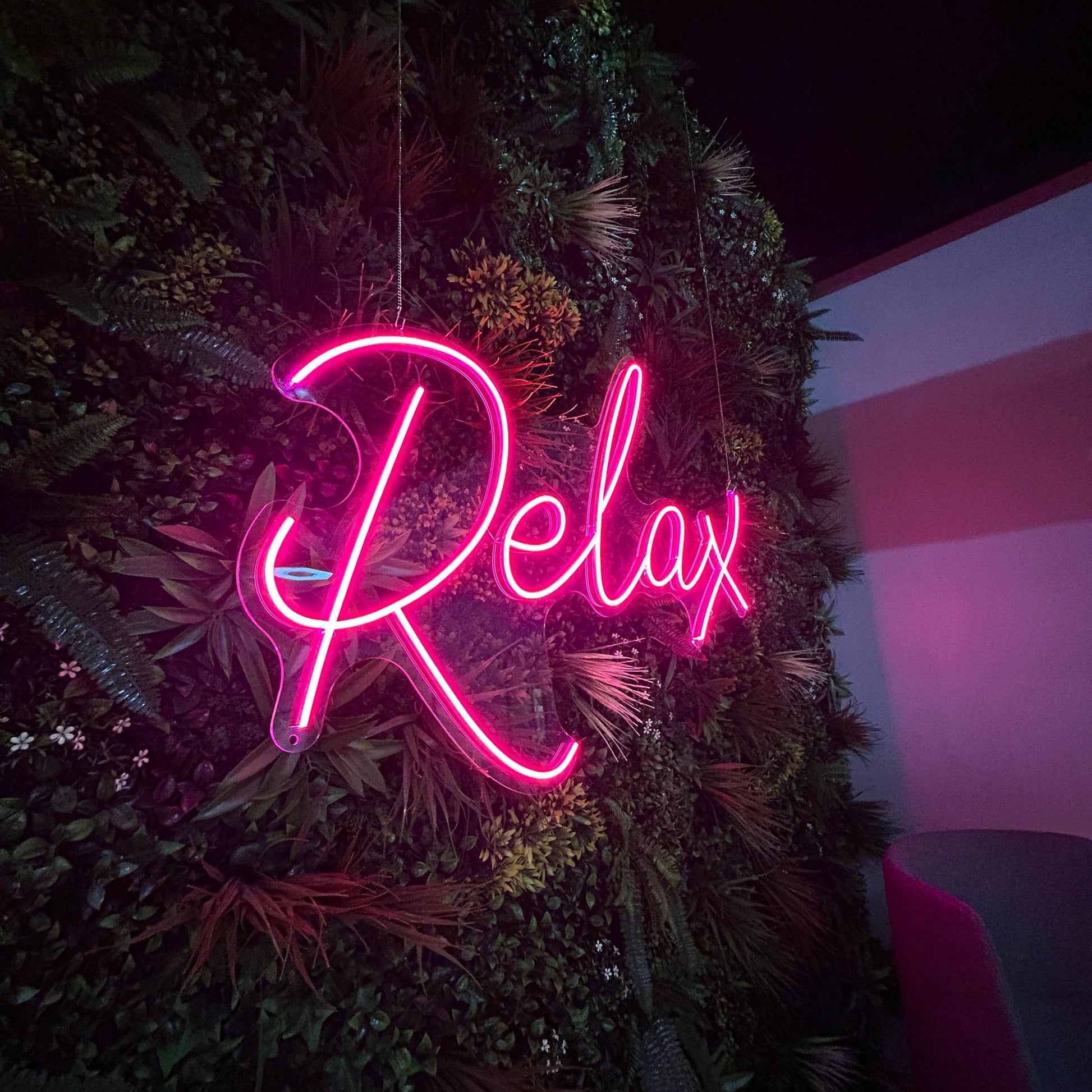 relax pink neon sign in birmingham office space for breakout room. trendy and modern decor.