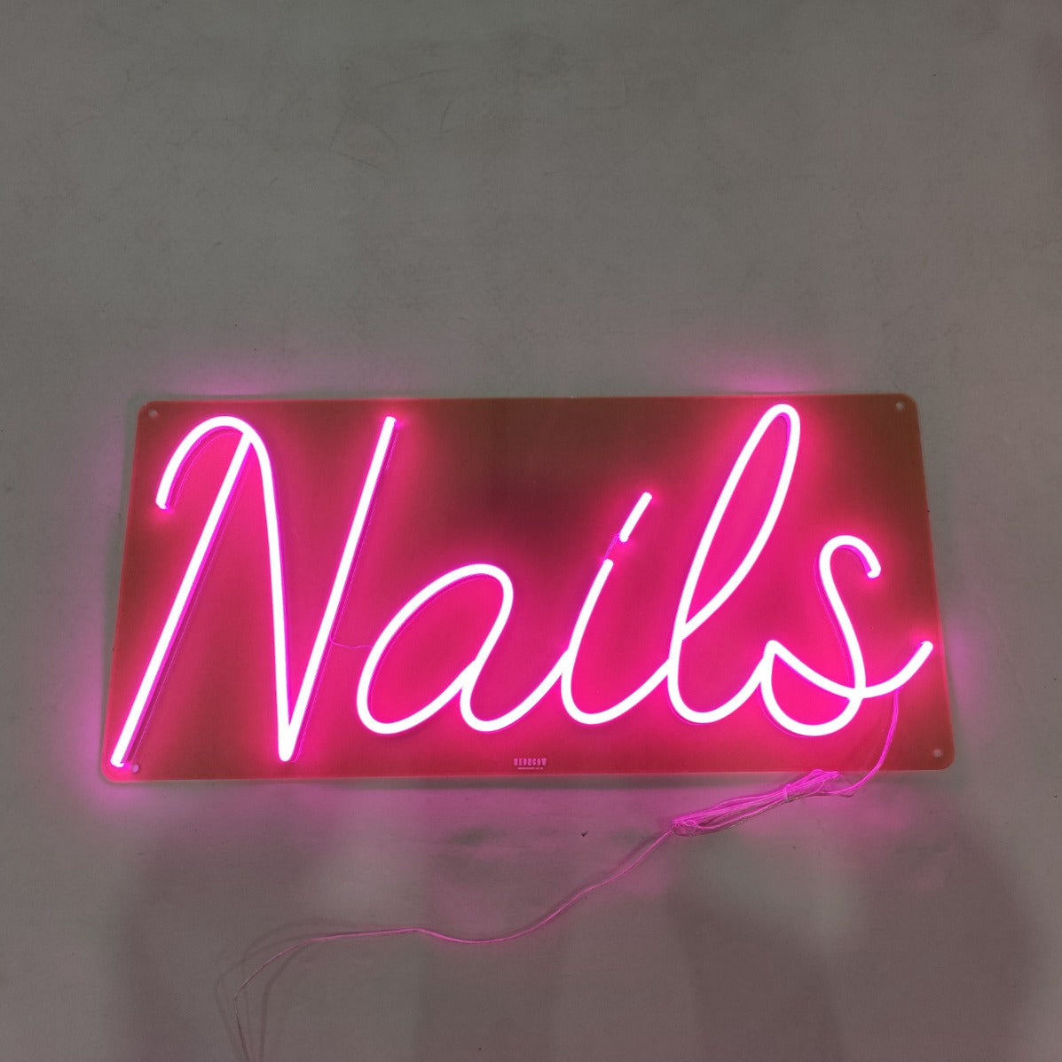 Pink neon sign for a modern nail salon, creating a stylish and welcoming vibe