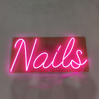 Pink neon sign for a modern nail salon, creating a stylish and welcoming vibe